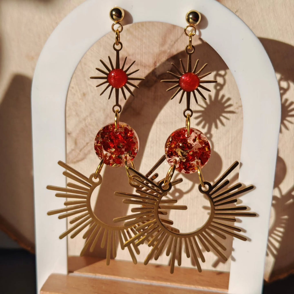 Soleils rayonnants et perles rouges